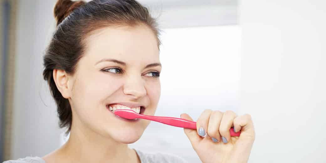 Photo of woman brushing her teeth